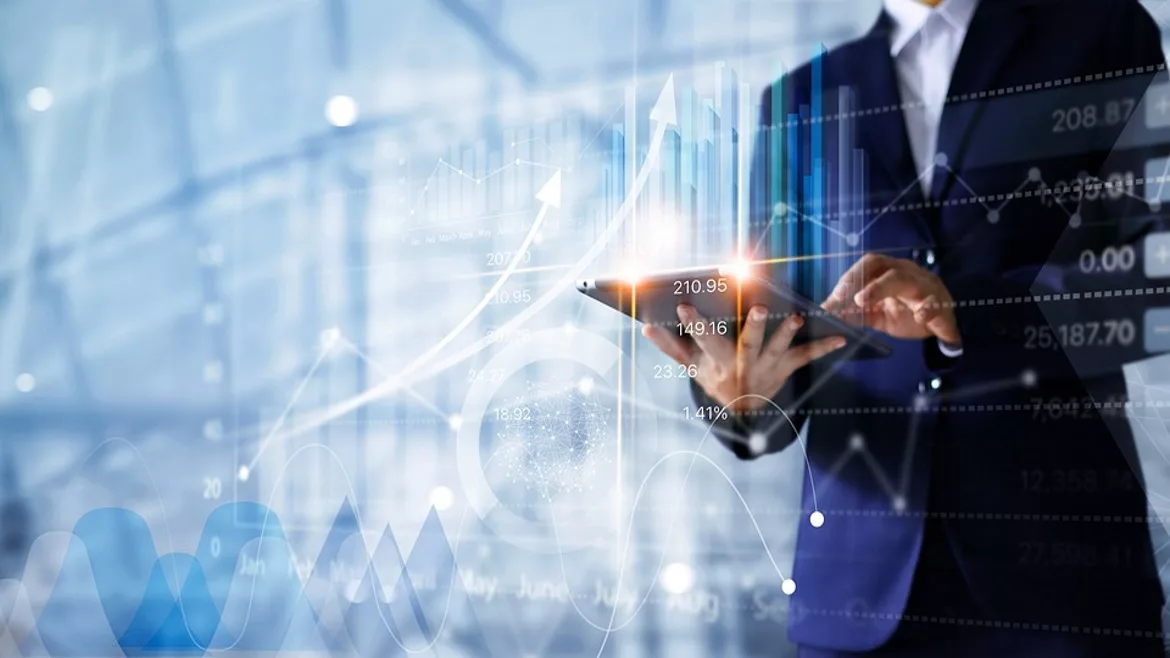 Person holding tablet with data figures