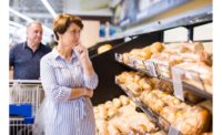 Woman in the grocery looking at bread