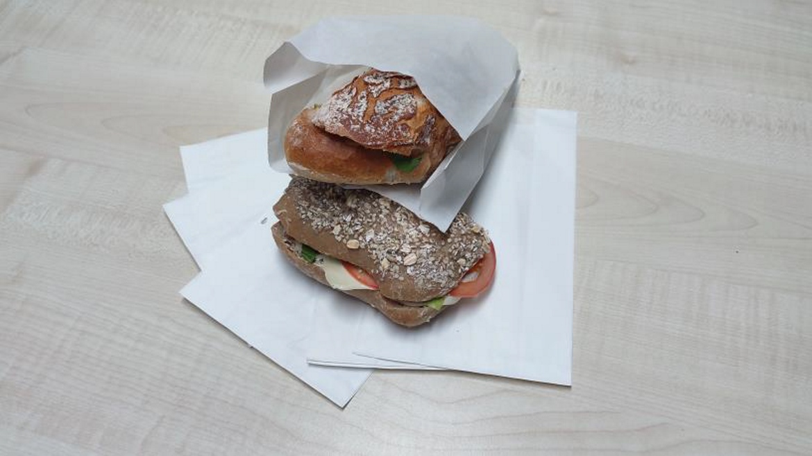 Archoma's paper material used to wrap a sandwich