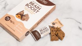 BrainMD Brain Boost Plant-Based Protein Bar's packaging on a white background
