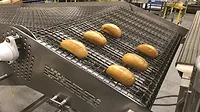 image of rejected bakery dough discharging from a conveyor image of rejected bakery dough discharging from a conveyor