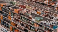 Rows of beverages stacked closely in grocery store isles