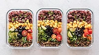 Image of three meal-prepped plant-based meals in glass containers. Image of three meal-prepped plant-based meals in glass containers.