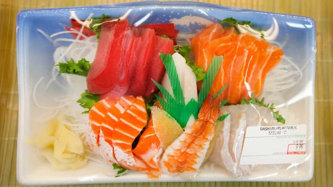 Image of seafood wrapped in plastic with a thermal label on the bottom stating the packaging information for the product.