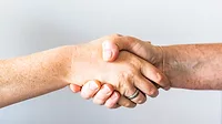 Two people shaking hands. Two people shaking hands.