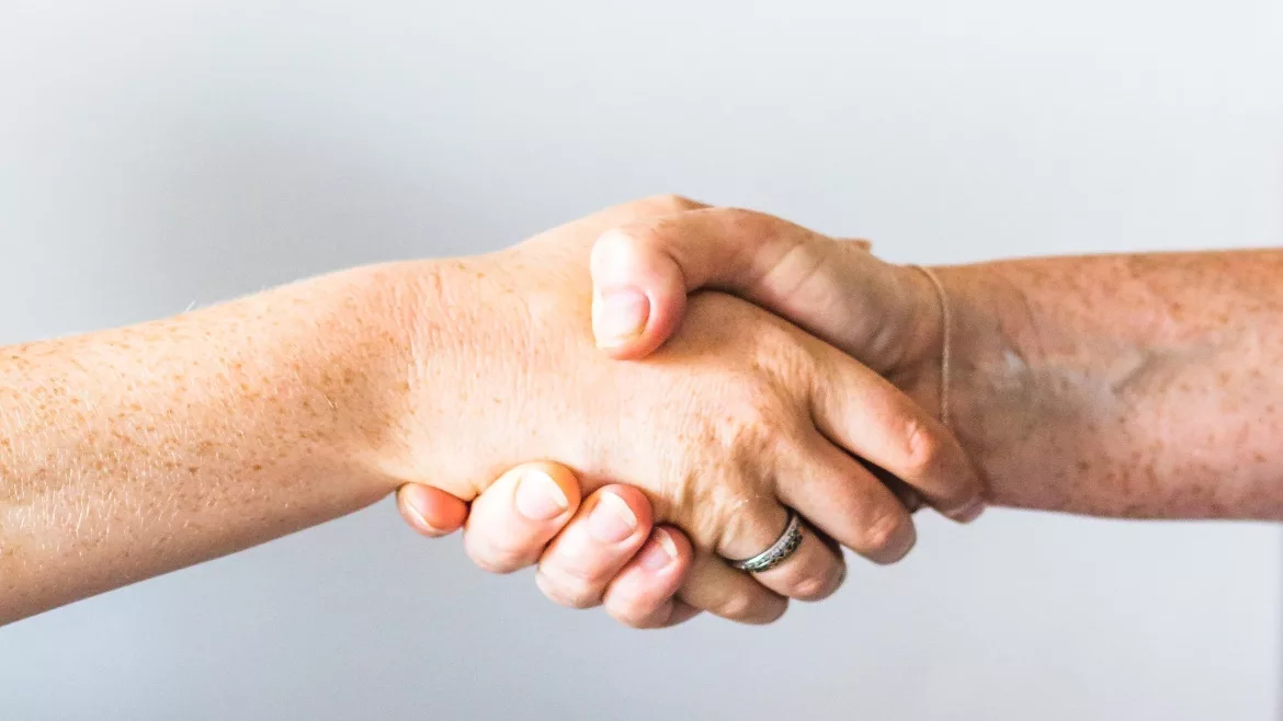 Two people shaking hands.