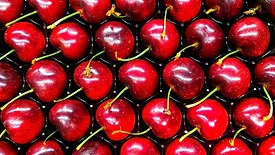 Photo of cherries aligned symmetrically on a tray