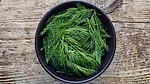 Fresh dill in a black bowl