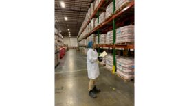 A person standing in a manufacturing facility