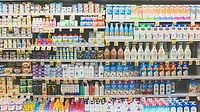 The dairy aisle of a grocery store with a refrigerator full of packaged food and beverages The dairy aisle of a grocery store with a refrigerator full of packaged food and beverages