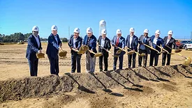 revalyu leadership lined up with shovels at its groundbreaking ceremony