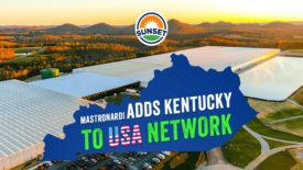 One of the new green house facilitie's photographed at sunset with the shape of Kentucky over it, saying, "Mastronardi adds Kentucky to USA network."