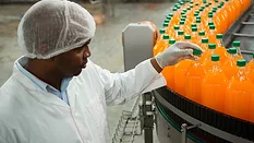 Worker examines bottling line