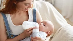 Mother bottle feeding baby