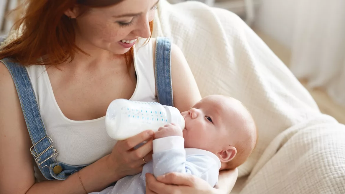 Mother bottle feeding baby