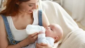 Mother bottle feeding baby