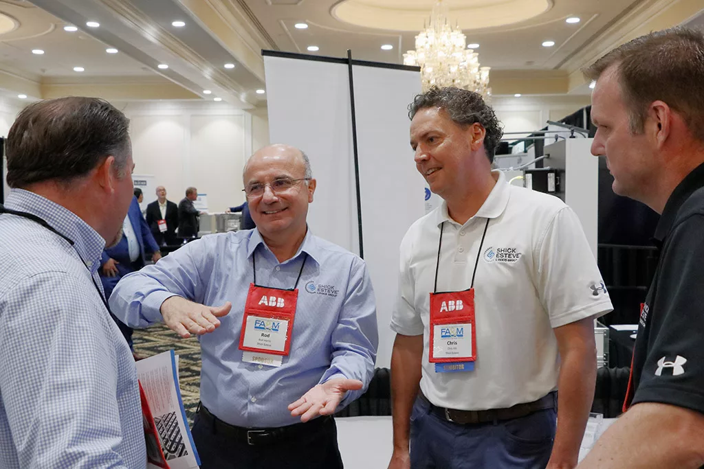 Rod Harris and Chris Hill of Shick Esteve network with attendees at their exhibitor booth at the Food Automation & Manufacturing Symposium and Expo.