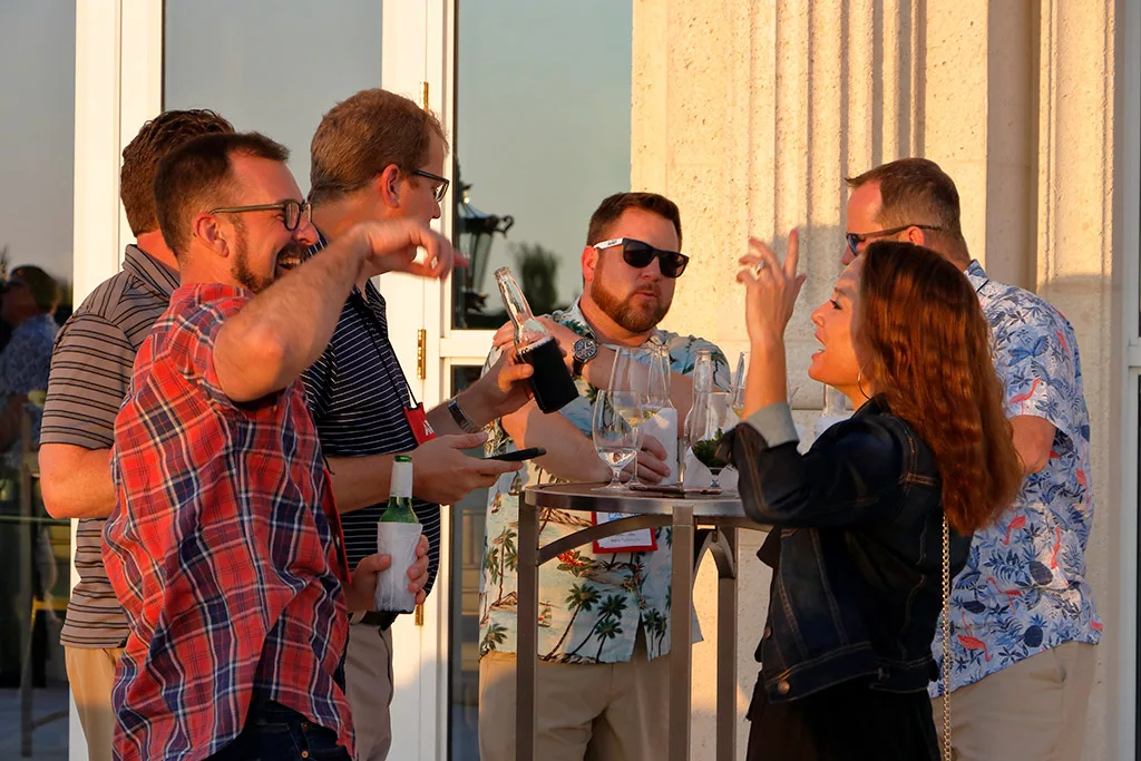 Food Automation & Manufacturing Symposium and Expo attendees laughing and networking outside at the Doral Resort in Miami.