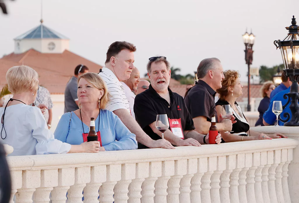 Food Automation & Manufacturing Symposium and Expo attendees standing at the balcony networking outside at the Doral Resort in Miami.