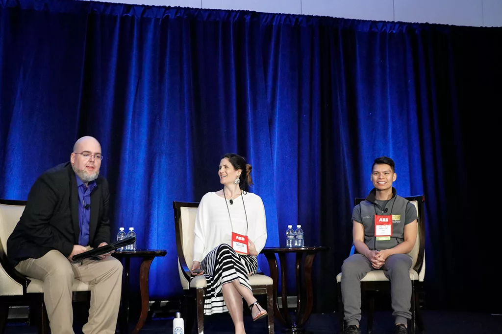 Three speakers on stage during a presentation at the 2019 Food Automation & Manufacturing Symposium and Expo.