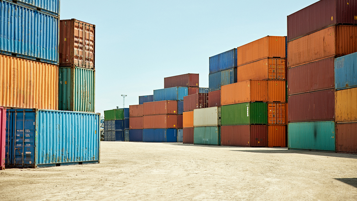 Numerous colorful shipping containers stacked high in a port