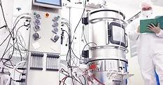 Scientist working with a bioreactor for cell culture.