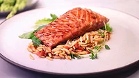 Austria-based Revo Foods’ 3D printed salmon fillet made from alternative proteins on a bed of rice on a white plate.