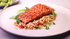 Austria-based Revo Foods’ 3D printed salmon fillet made from alternative proteins on a bed of rice on a white plate.
