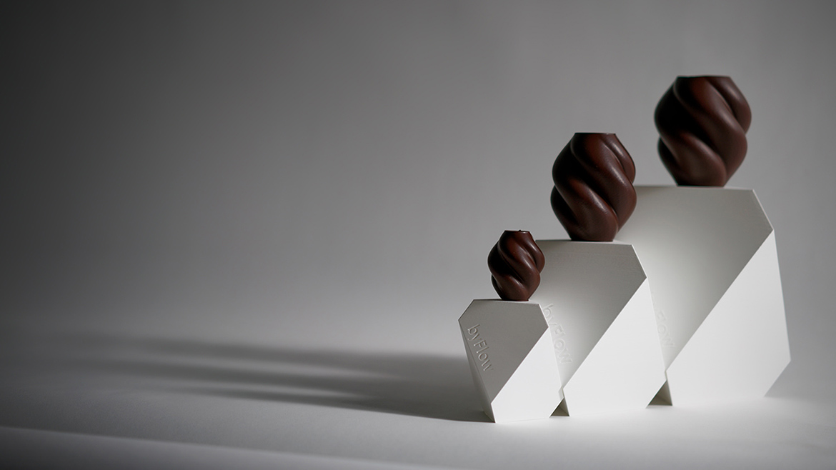 byFlow’s OPUS special geometric-shaped chocolates on top of white pedestals.