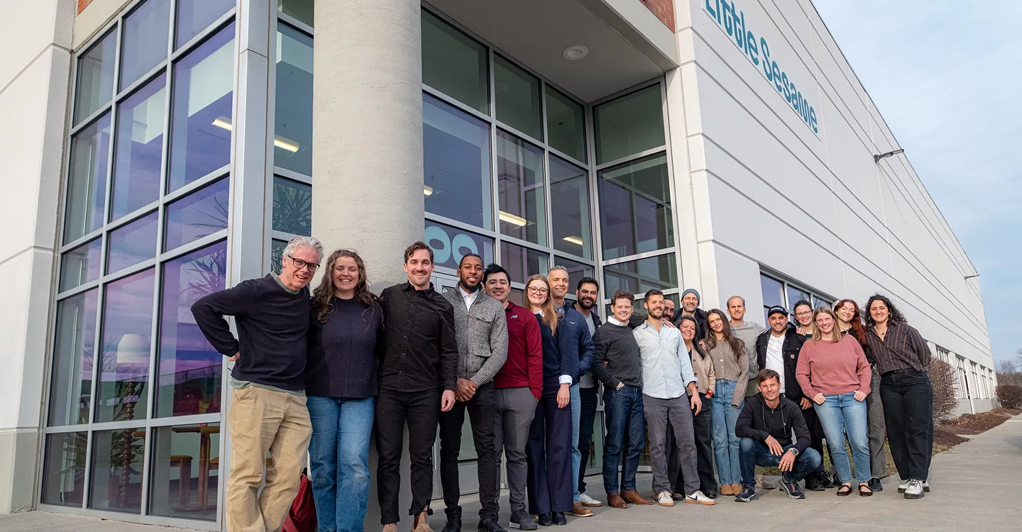 Little Sesame staff standing outside at the opening of its new facility in Capitol Heights, Maryland with a ribbon-cutting ceremony.
