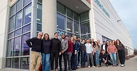 Little Sesame staff standing outside at the opening of its new facility in Capitol Heights, Maryland with a ribbon-cutting ceremony.