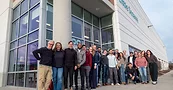 Little Sesame staff standing outside at the opening of its new facility in Capitol Heights, Maryland with a ribbon-cutting ceremony.