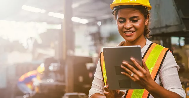 Working in safety gear on her tablet.
