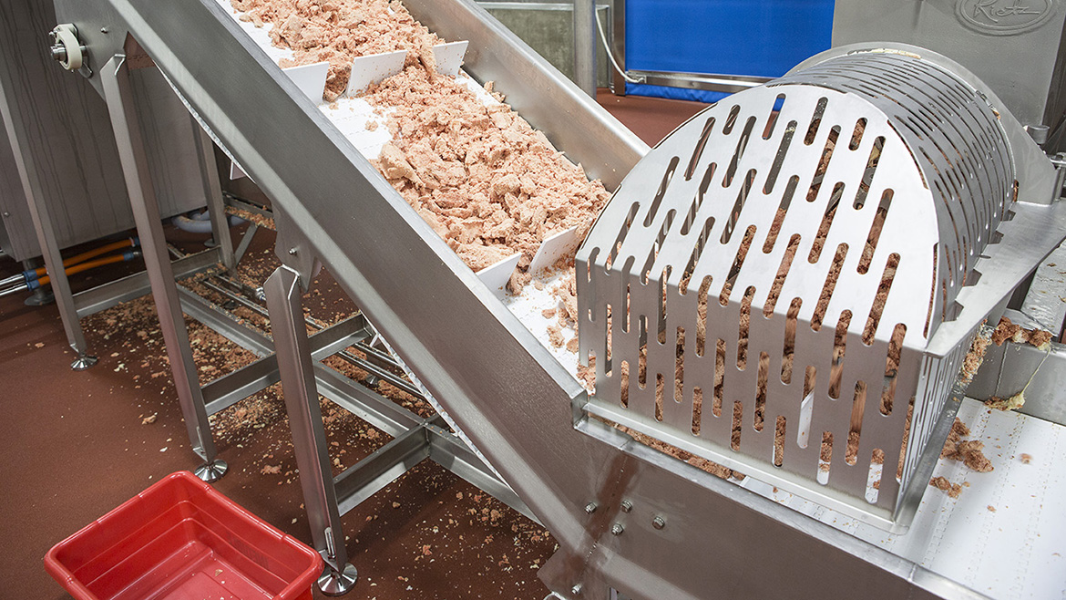 Food product going down a meat conveyor.