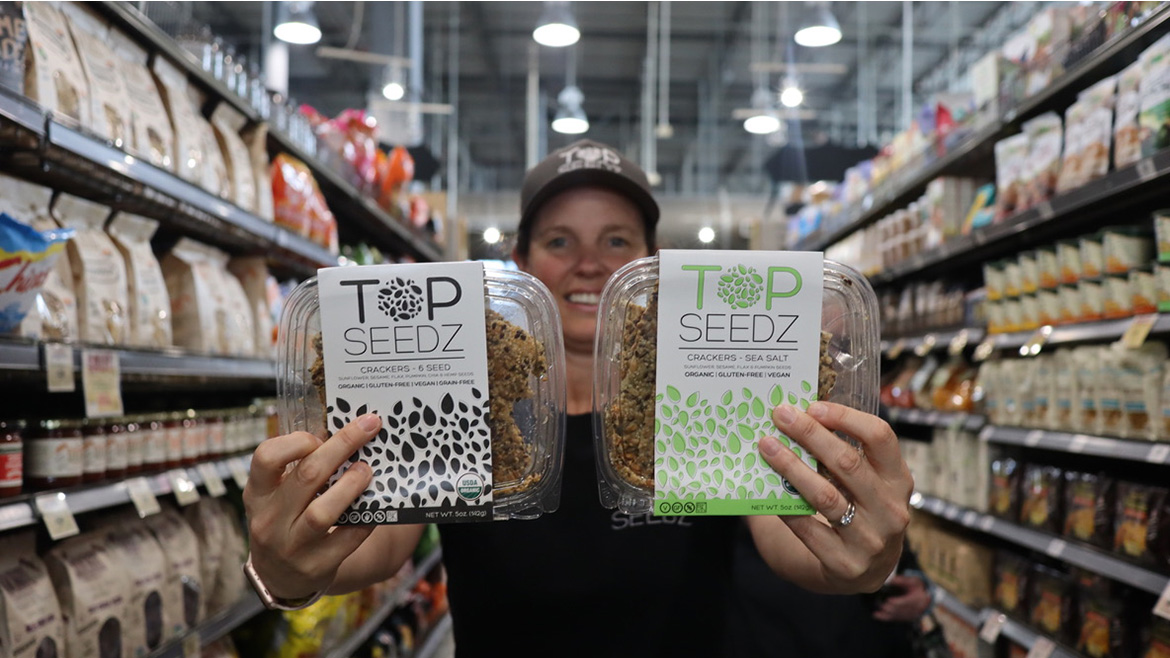 Rebecca Brady, CEO of Top Seedz, is holding two products with CEO Rebecca Brady, shown holding two products in Top Seedz’s former clamshell packaging.