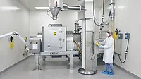 Munson rotary batch mixer Worker in safety clothing working with a 40-cu.-ft. capacity Munson Model 700-TS-40-SS rotary batch mixer.