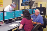 Operators at the controls of Wild Turkey's new batch process control