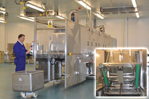 A GoldCoast Salads operator checks the controls on an ET75 tunnel washing machine