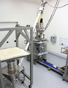 The Hapman Helix flexible screw conveyor conveys imported rice from its integral stainless steel hopper into a packaging machine
