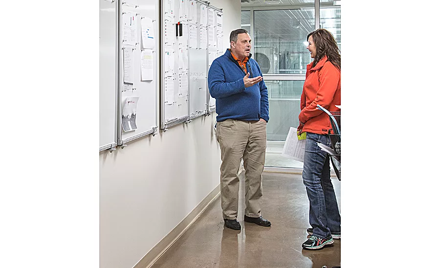 Dan Sileo confers with team member