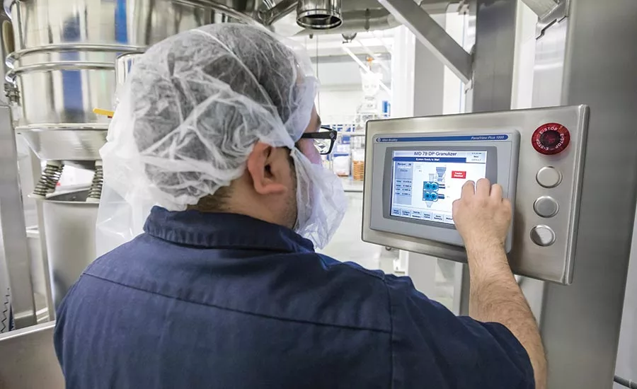 SaltWorks employee using controls for grinder