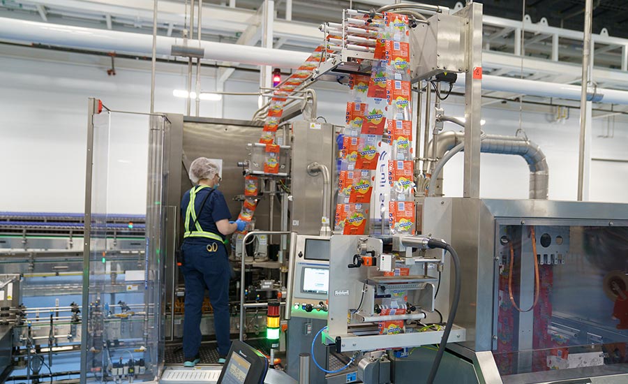 Photo 2: An operator loads film into a labeler.