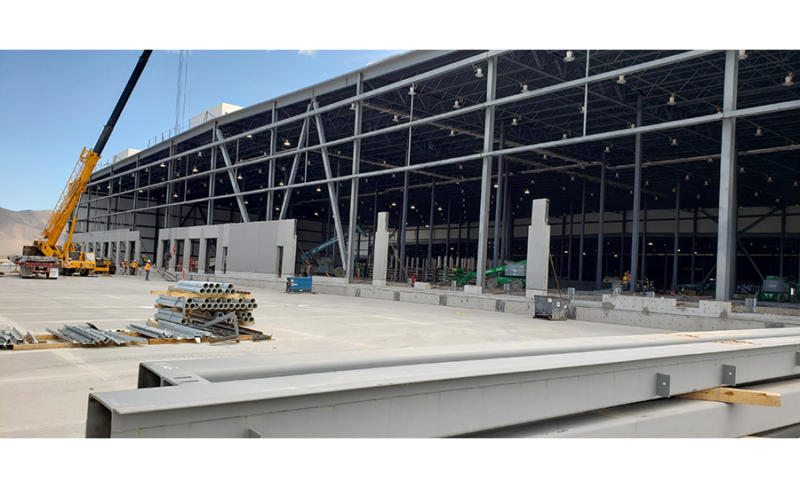 Crews installing precast building walls