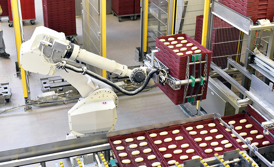 Robots used in industrial production line of bakery products. 