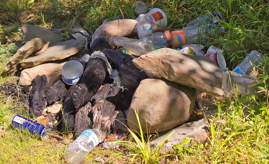 trash left on the shore of a reservoir