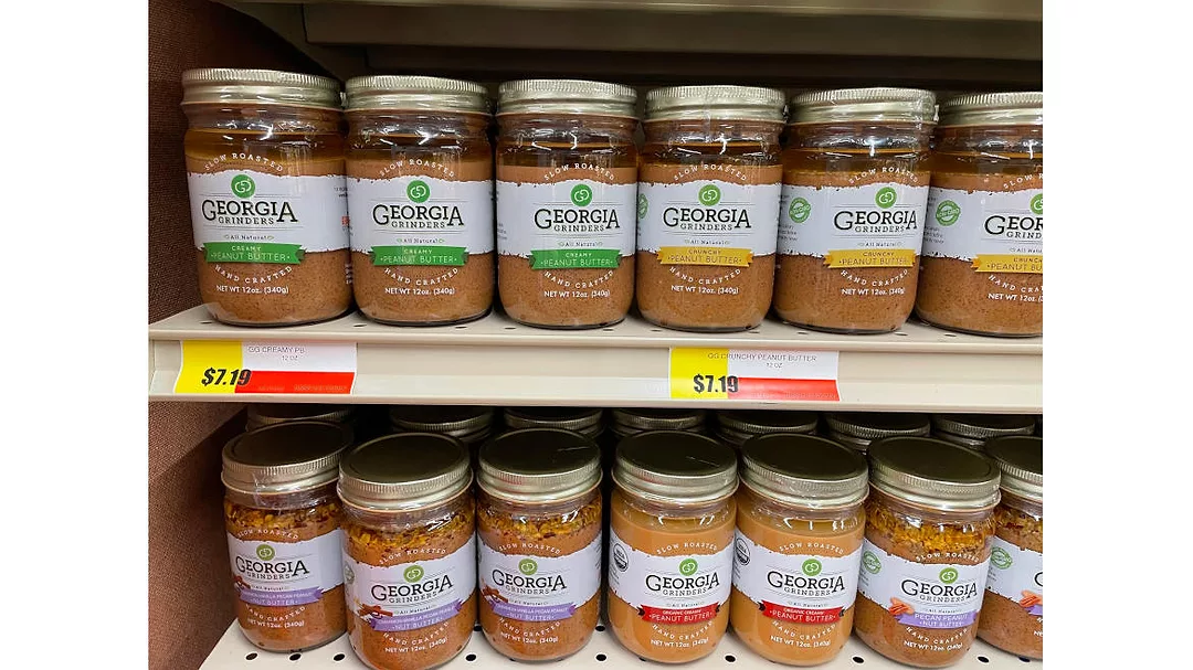 Rows of Georgia Grinder’s peanut butter on a grocery shelf.