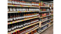 An entire grocery aisle stocked with products.