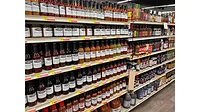 An entire grocery aisle stocked with products. An entire grocery aisle stocked with products.