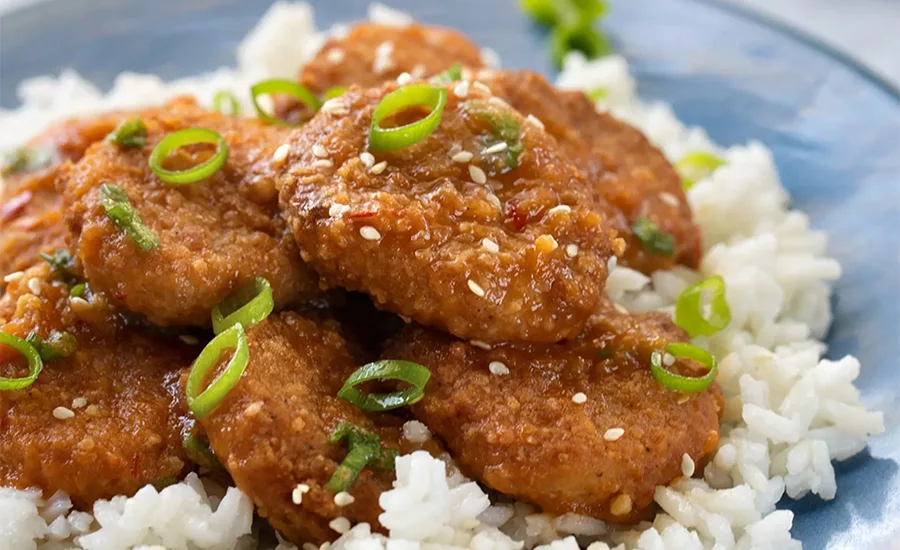 Rebellyous tenders in General Tsos Chicken on a bed of white rice