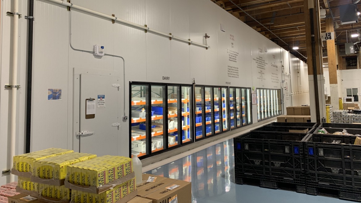 Interior of the food bank, showcasing the stock of non-perishable and refrigerated foods.